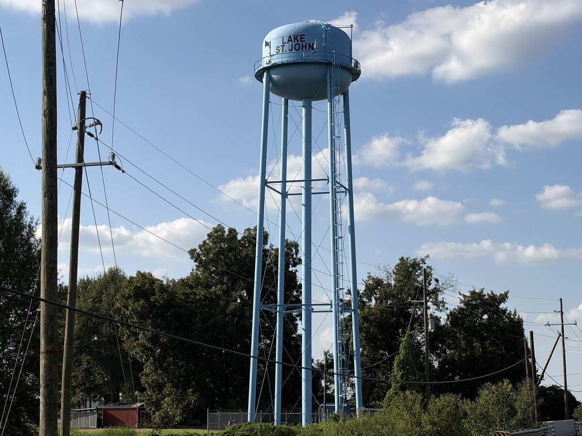 The Lake St. John water tower beside the road through the community
